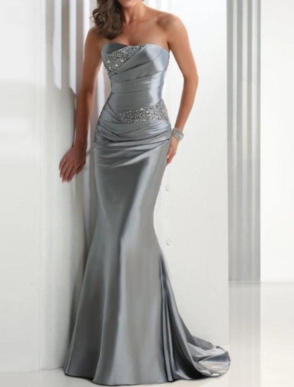 A woman wearing the strapless mermaid trumpet evening dress, in a different pose, highlighting the overall design.