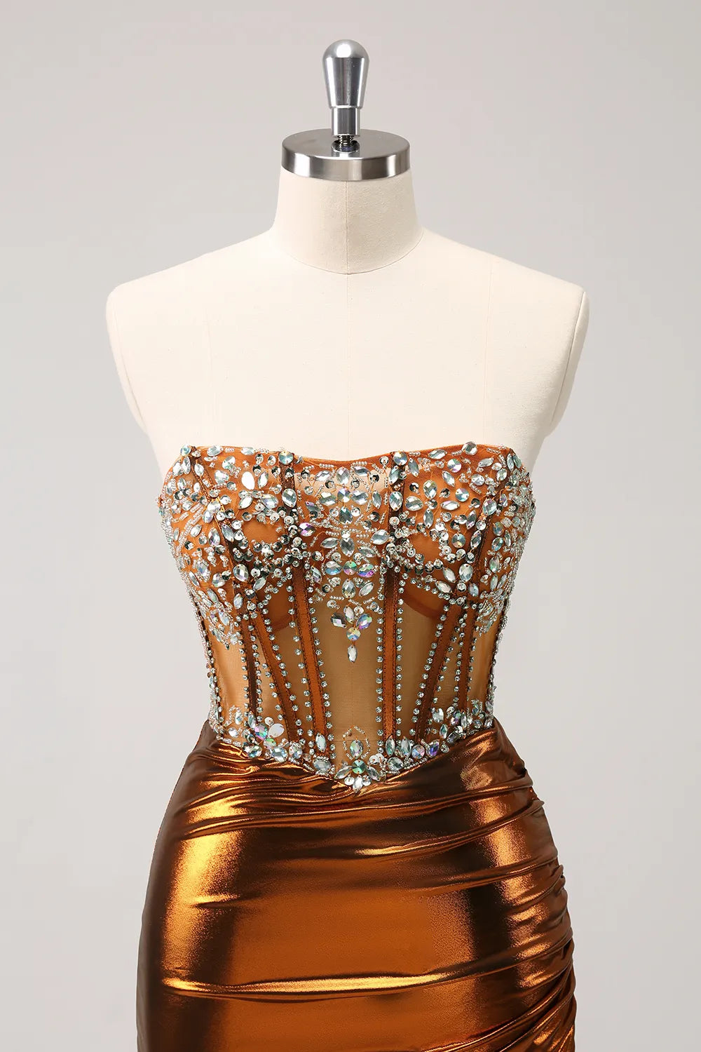 Elegant copper strapless bodycon dress with ruched details and sparkling beading.