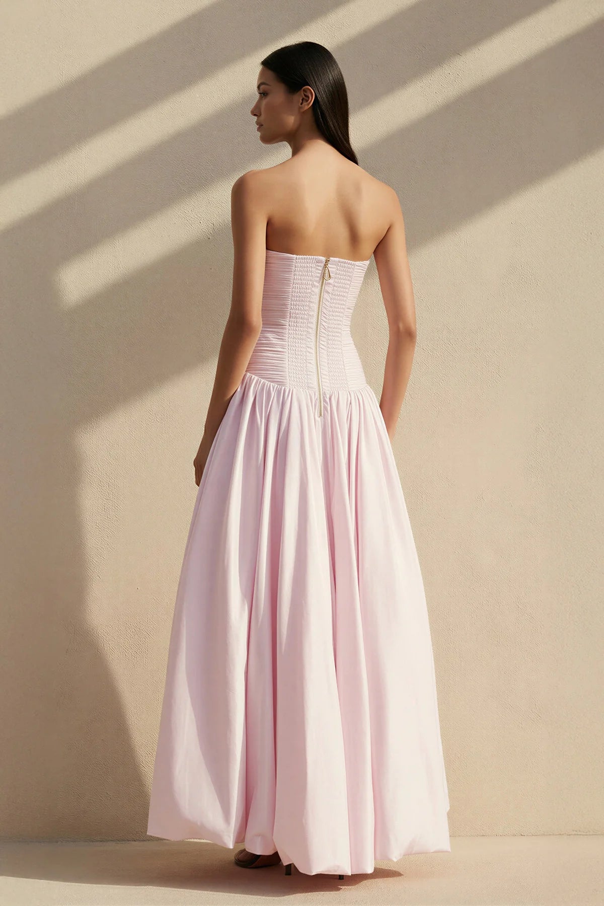 Back view of the floor-length formal gown, highlighting the balloon skirt.