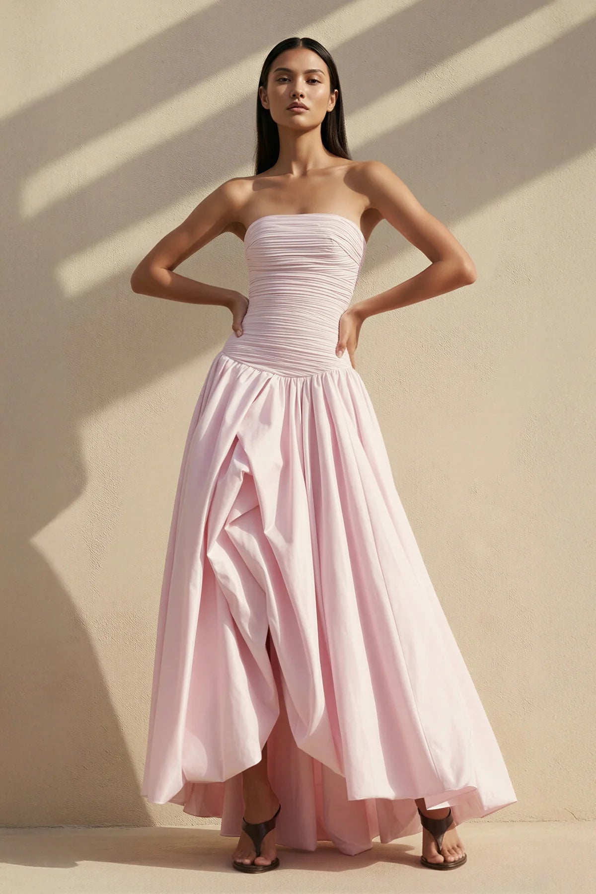 Side profile of the strapless evening gown, showing the ruched waist detail.