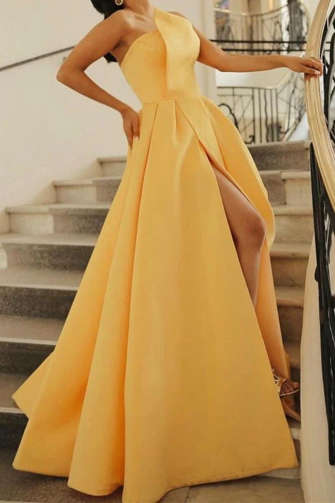 Side profile of a model showcasing the slit on a long satin prom dress.