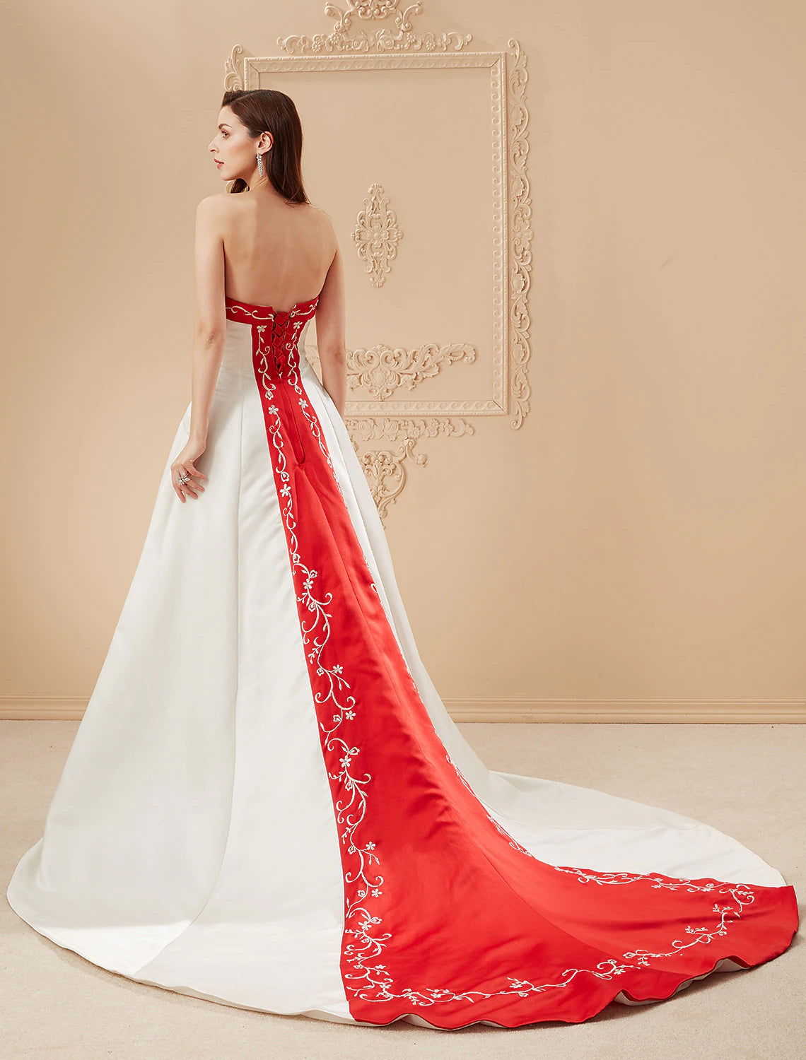 Bride posing in the luxurious open back satin ball gown wedding dress.
