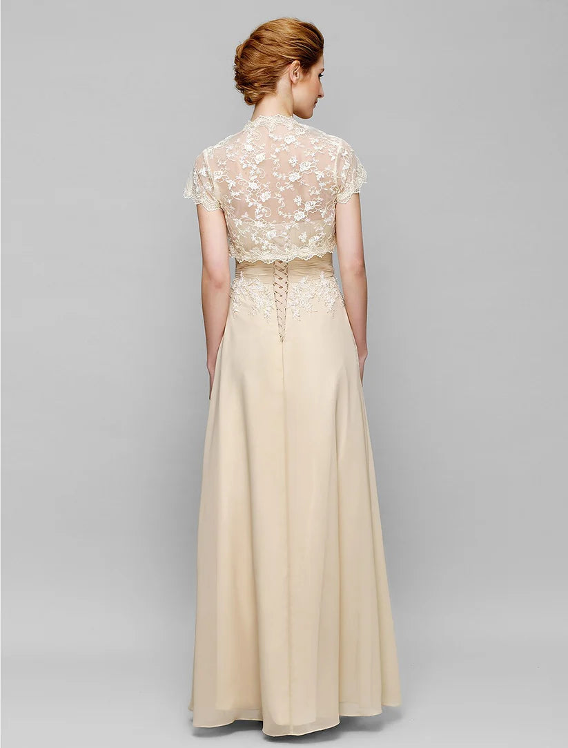 Back view of a woman in a strapless chiffon lace Mother of the Bride dress with lace-up detail.