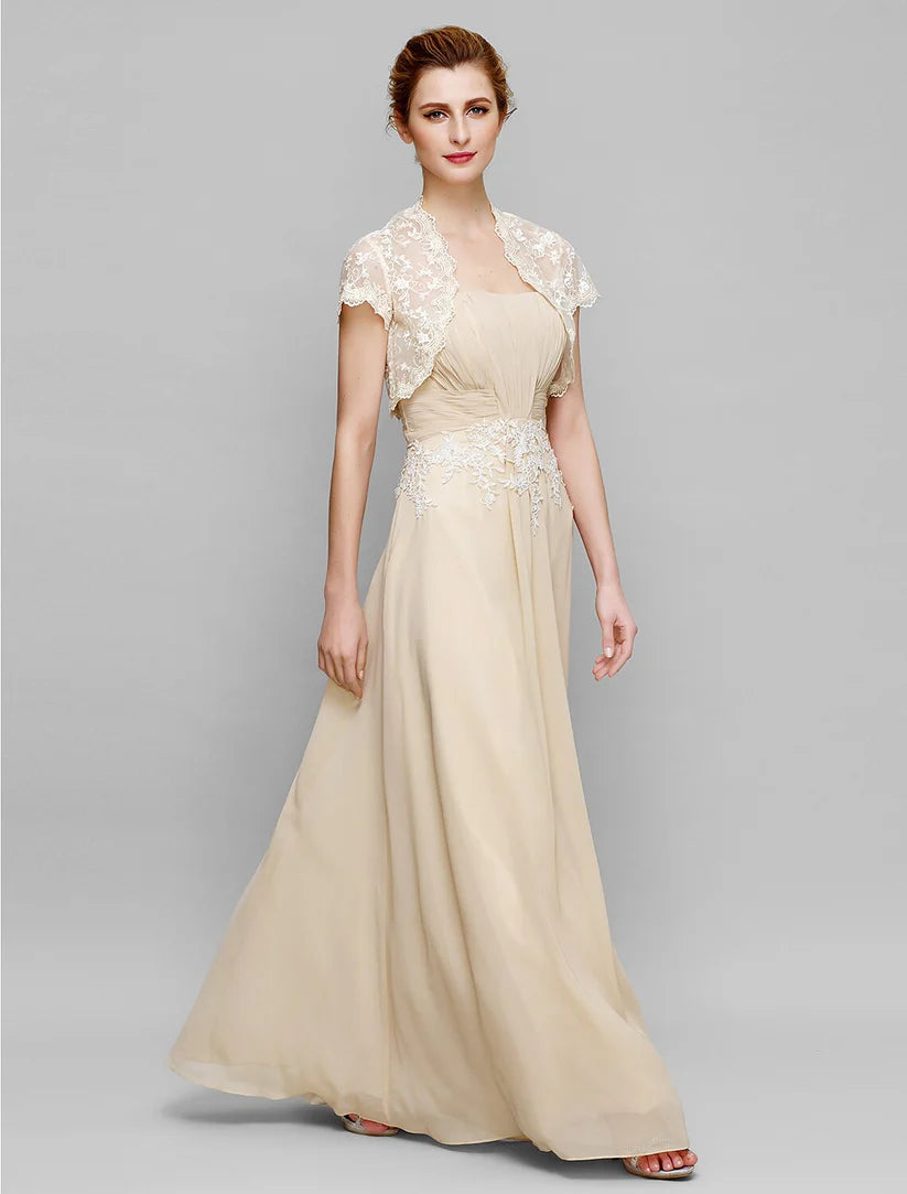 Side profile of a woman in a formal strapless sheath dress with ruched draping.