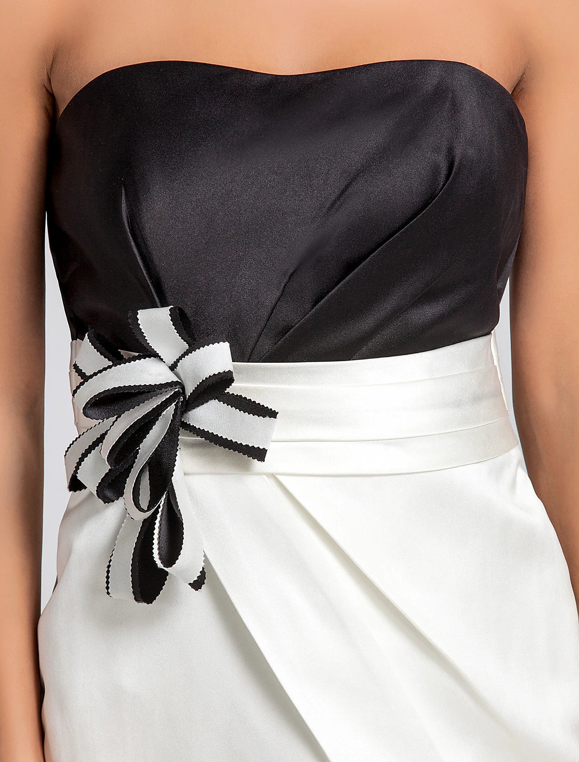 Side profile of a model showcasing a knee-length satin bridesmaid dress.