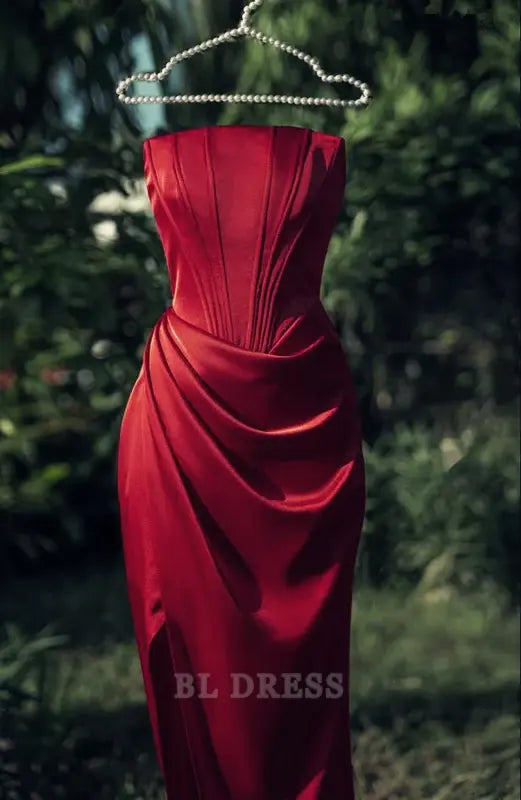 Burgundy satin formal dress with strapless neckline and elegant side slit.