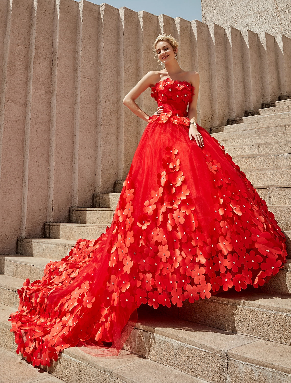 Back view of a strapless wedding ball gown showing open back and chapel train.