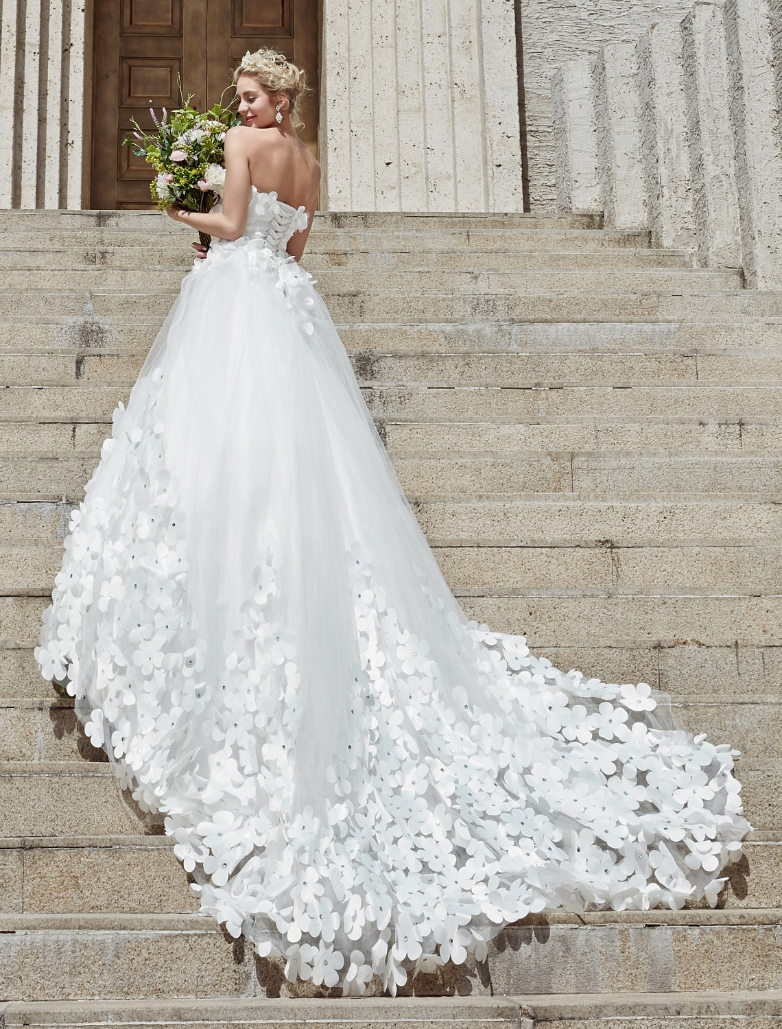 Close-up of lace and crystal details on a formal wedding dress.