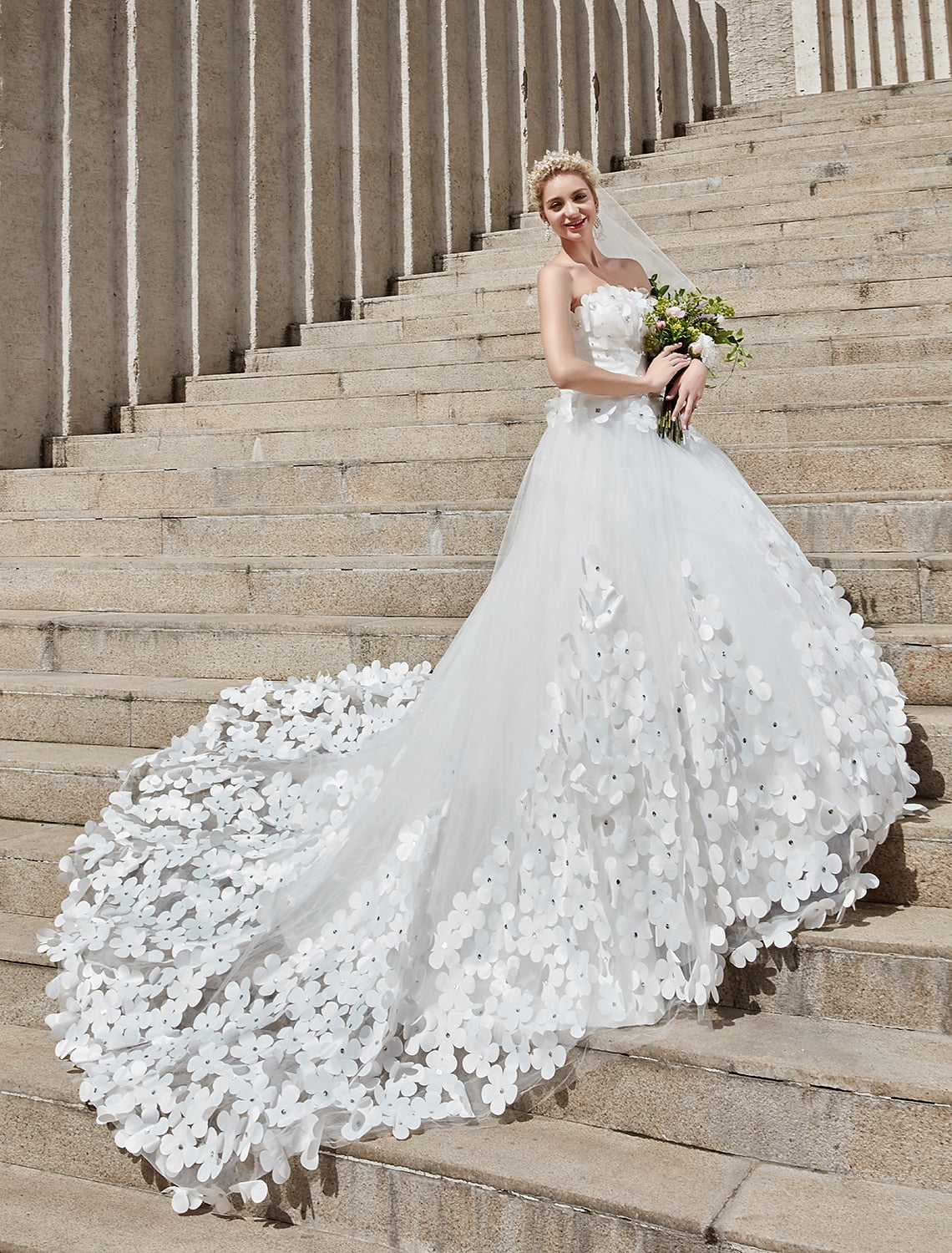 Bride posing in a formal ball gown wedding dress with floral lace.