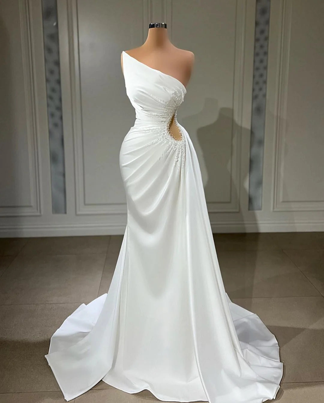 Elegant strapless square neck satin wedding gown with a chapel train.