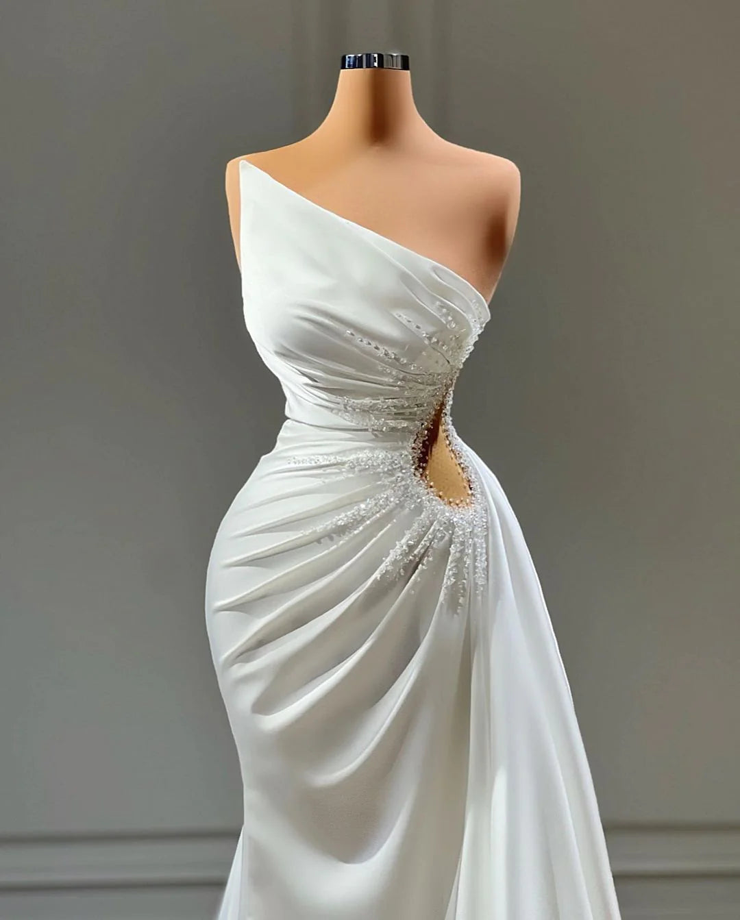 Back view of a sleek sheath satin bridal gown with a chapel train.