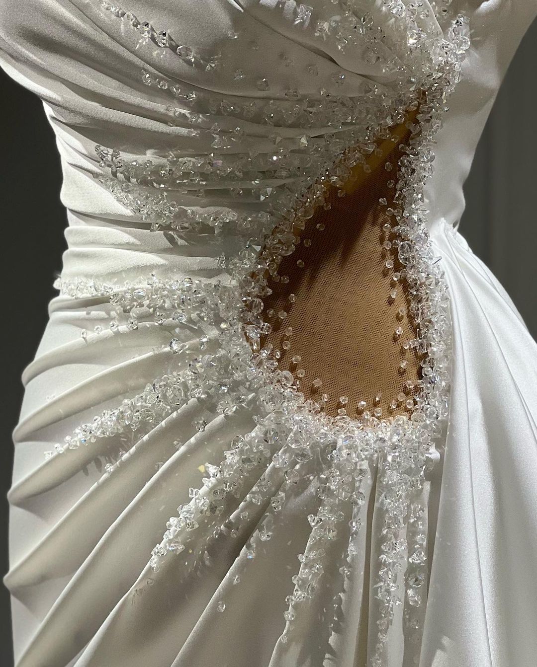 Side view of a modern strapless square neck wedding dress.