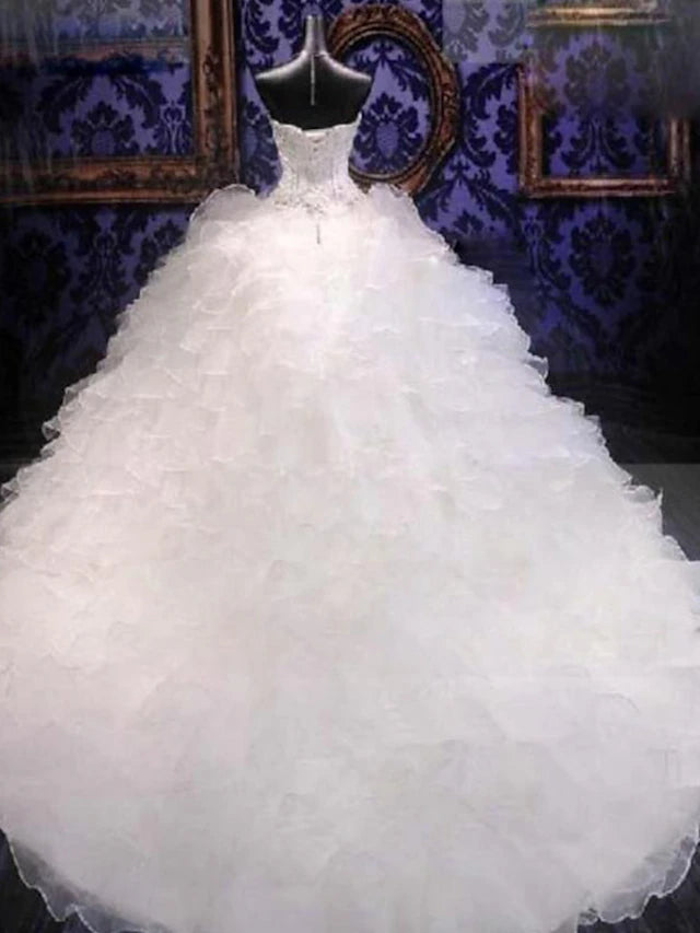 Back view of the organza ball gown wedding dress showing chapel train and beading.
