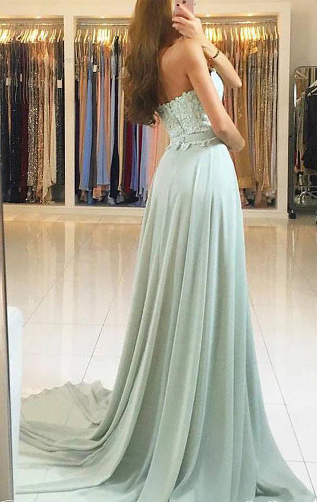 Model wearing an elegant strapless lace and chiffon maxi prom gown.