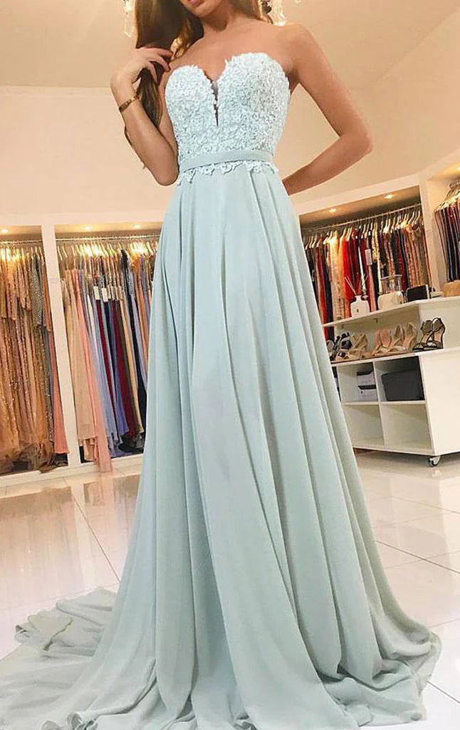 Back view of the strapless lace and chiffon prom dress, showcasing its flowing skirt.