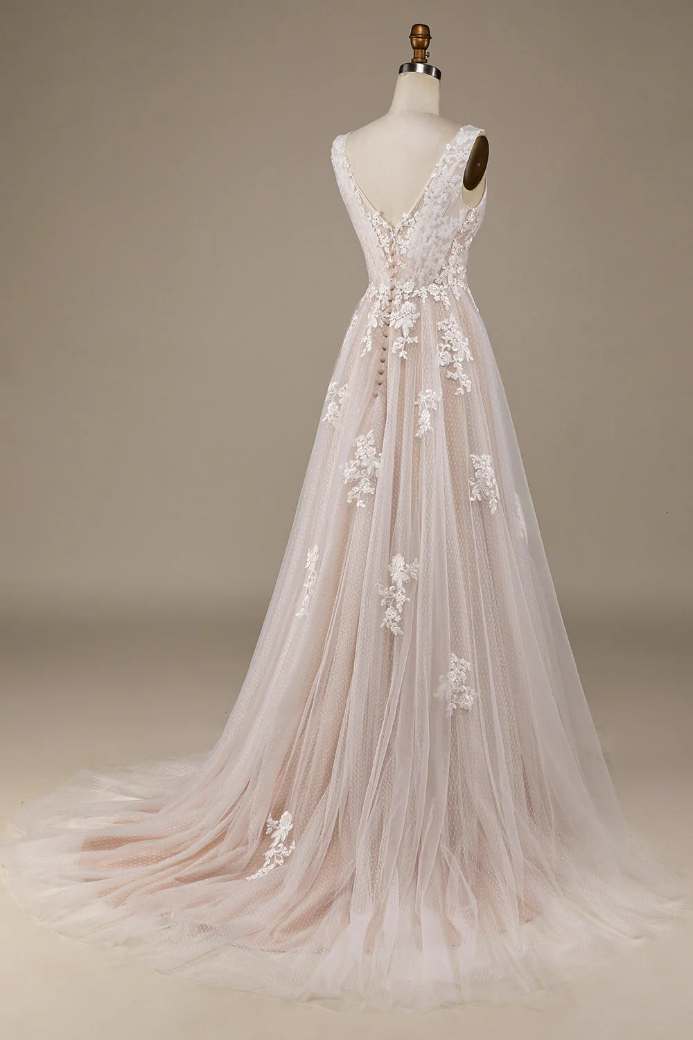 Side view of a bride wearing a tulle and lace wedding gown, showcasing the intricate lace details.