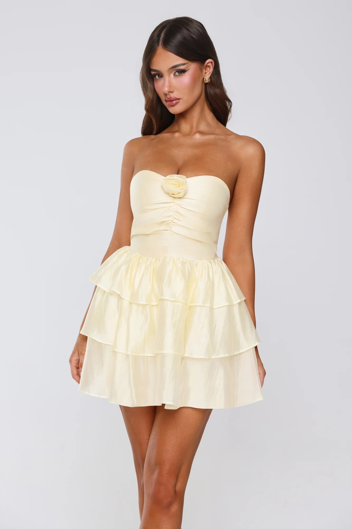 Side view of yellow strapless tiered ruffle dress.