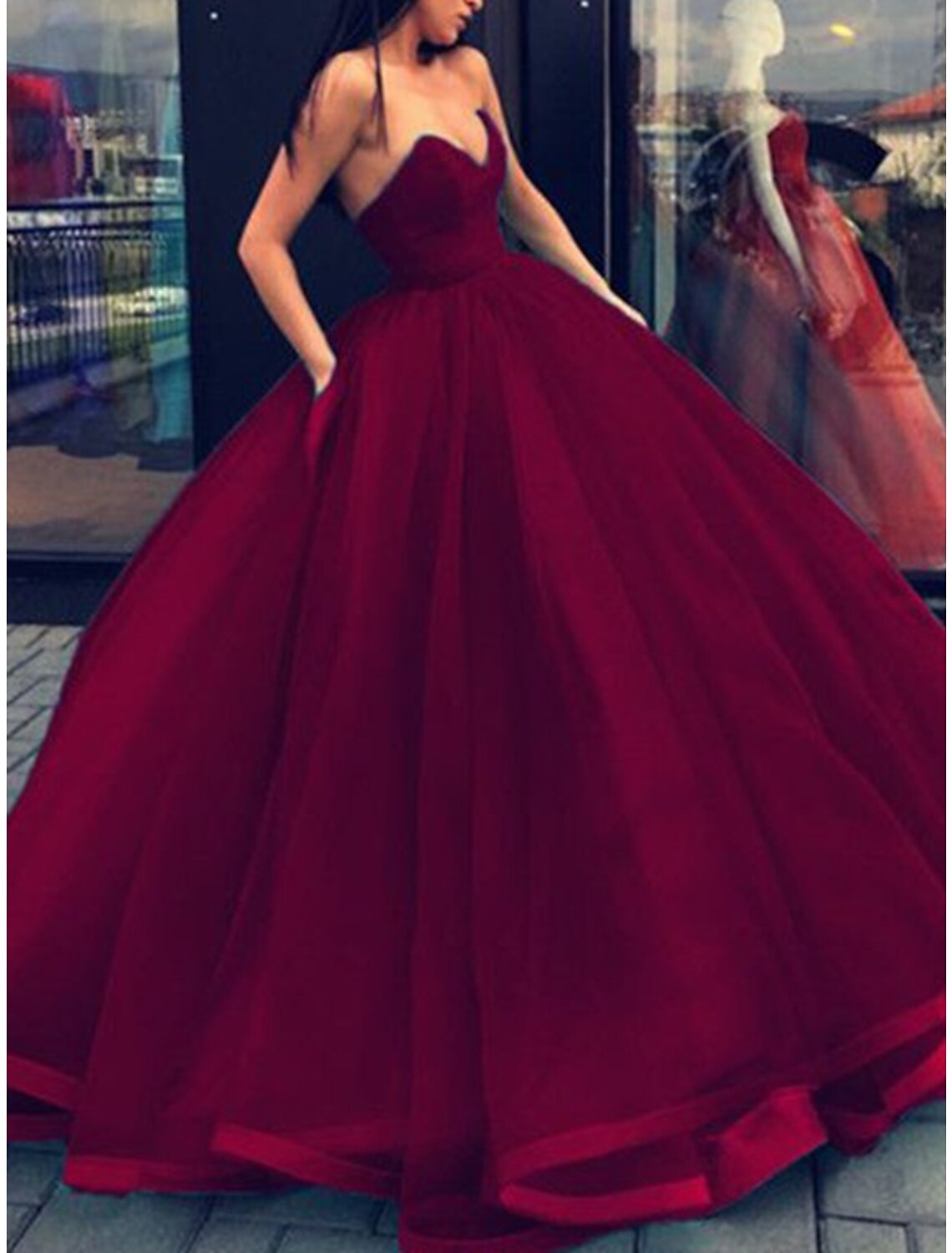 Side view of the floor-length strapless quinceanera dress.