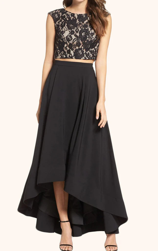 Model wearing an elegant two-piece high-low prom gown with a strapless top.