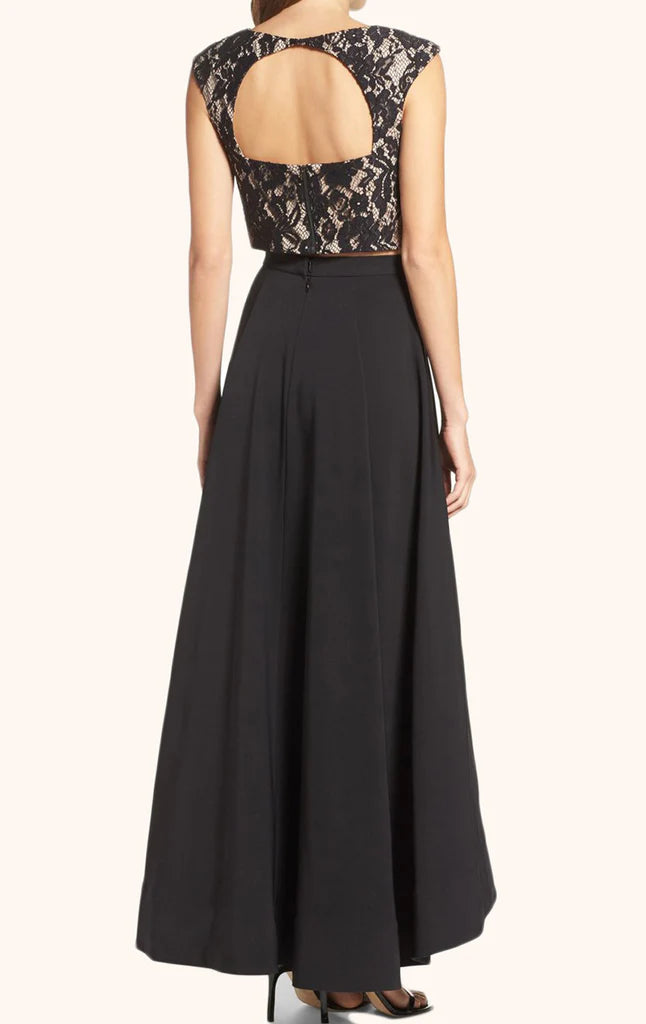 Model posing in a chic two-piece high-low cocktail party dress with a flowing skirt.