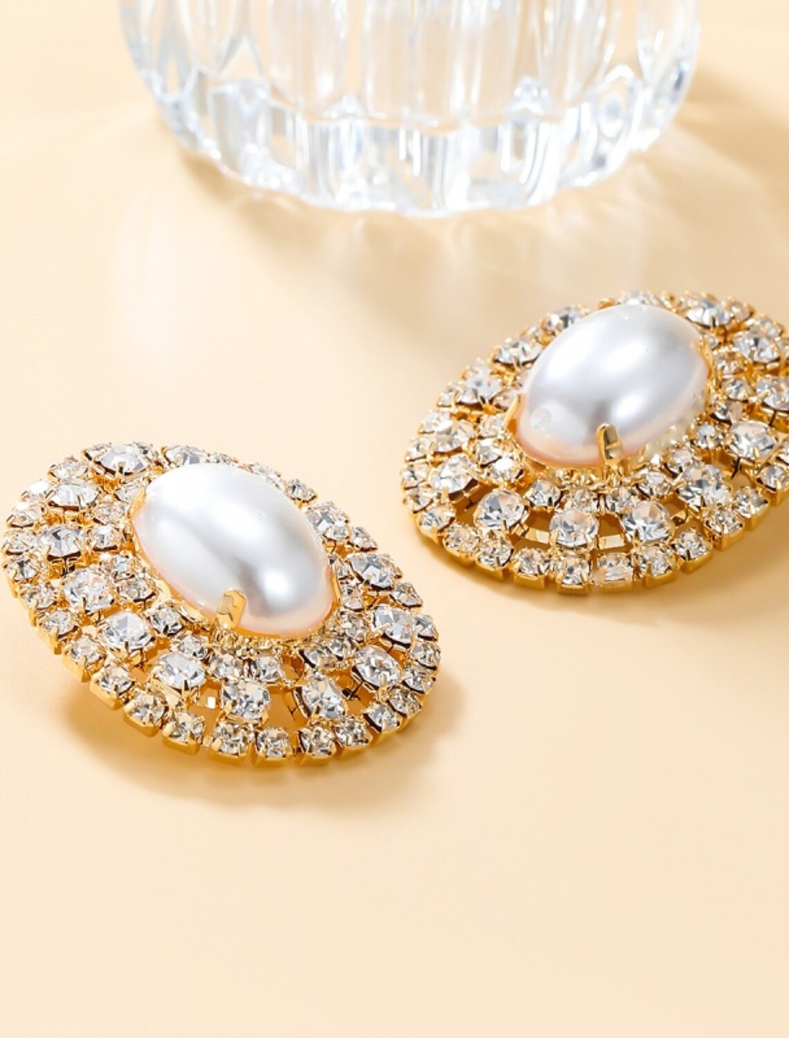 Close-up of a gold-tone stud earring.