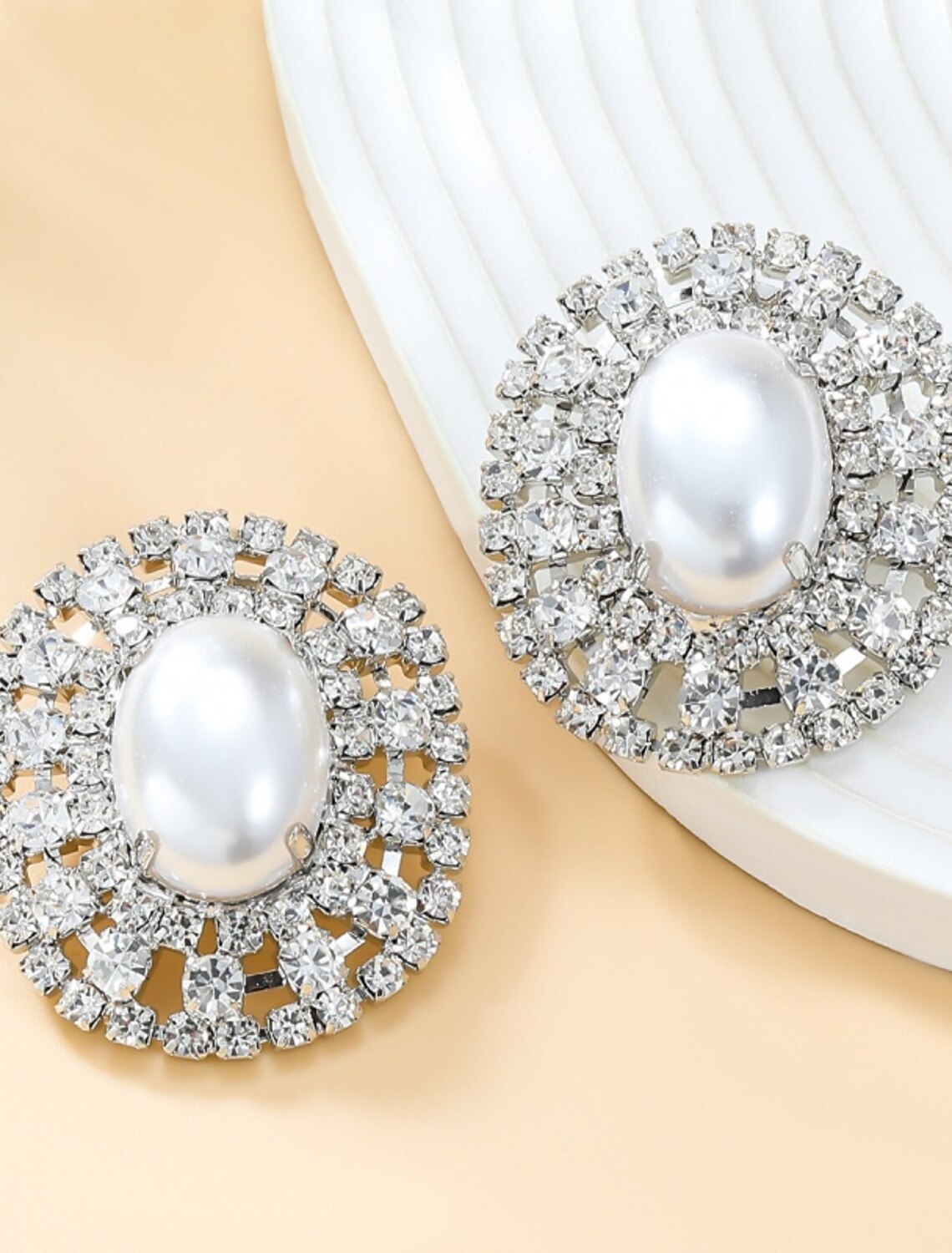 Close-up of a silver-tone stud earring.