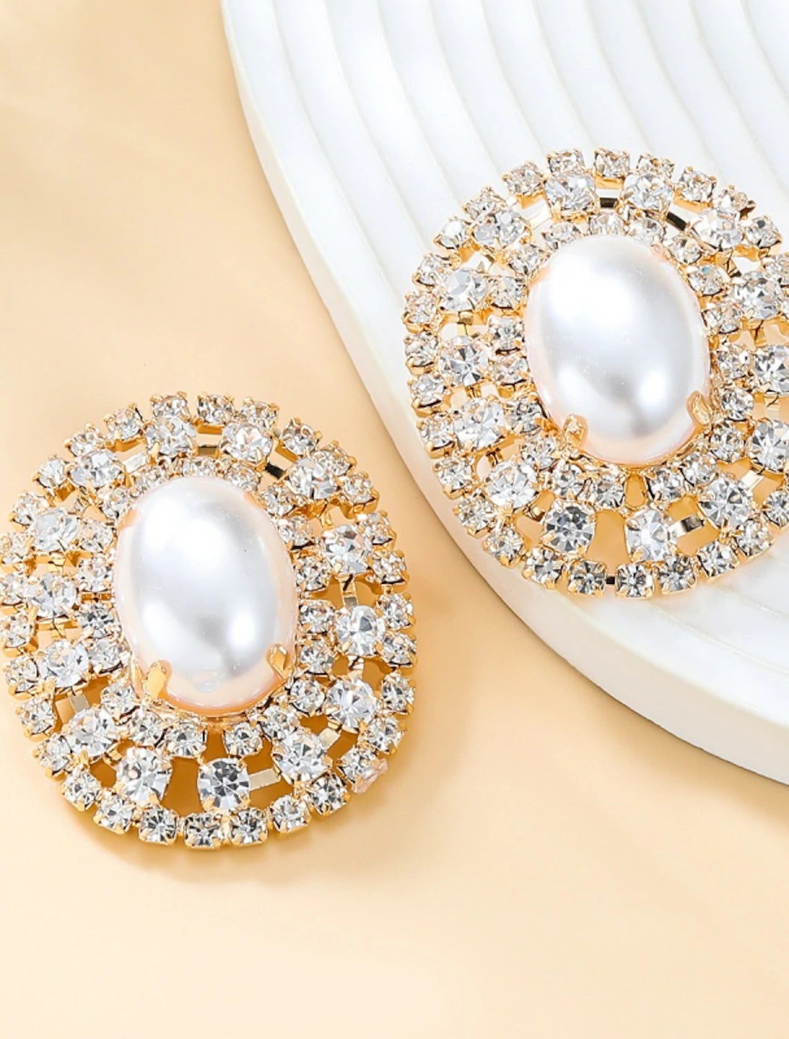 Pair of stud earrings on a display.