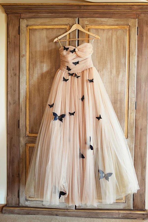 Close-up of the sweetheart neckline and delicate butterfly ruffle details on a bridal gown.