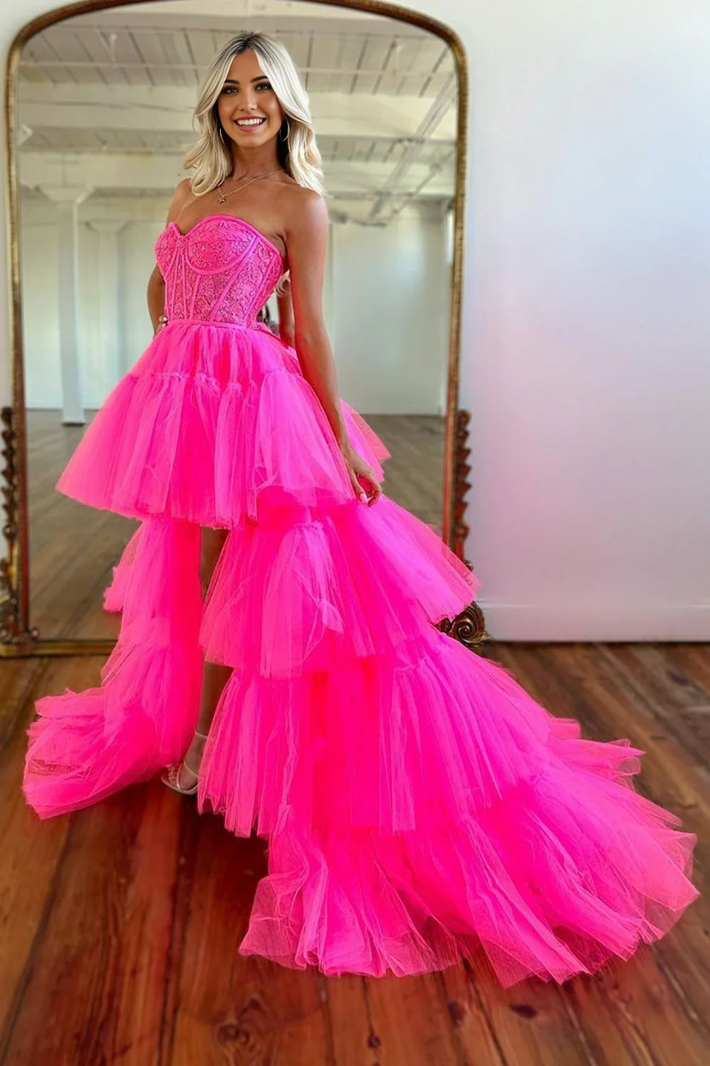 Back view of hot pink tulle evening gown with flowing train.