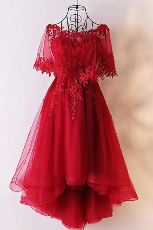 Model wearing a sweetheart appliques high-low tulle prom dress with lace-up back.