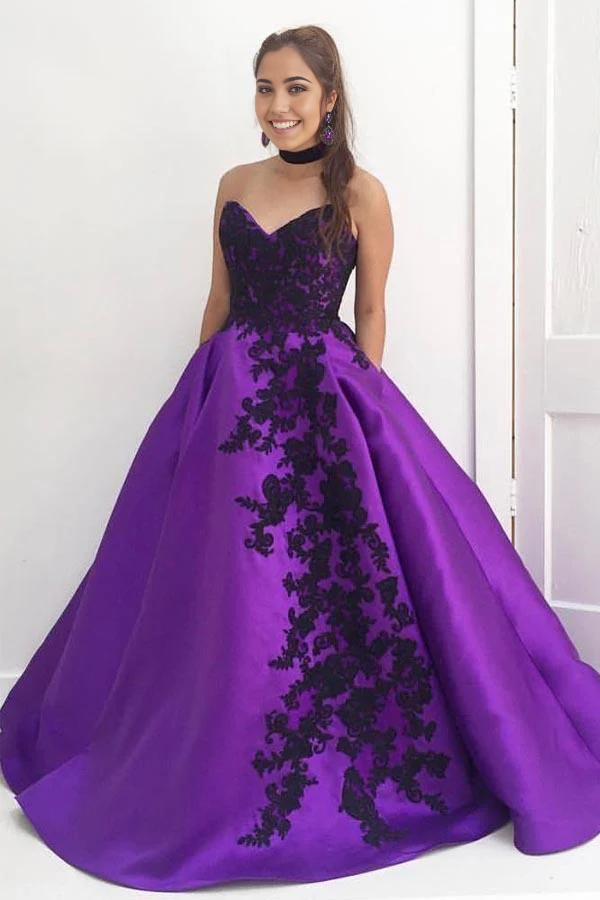 Purple ball gown with sweetheart neckline and black appliques.