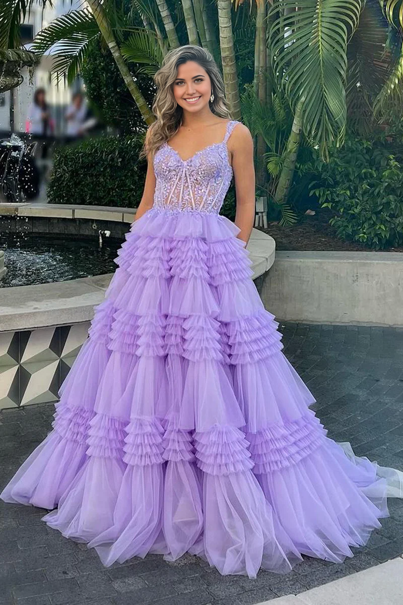 Model wearing a lavender tulle ball gown with sweetheart neckline and appliques.