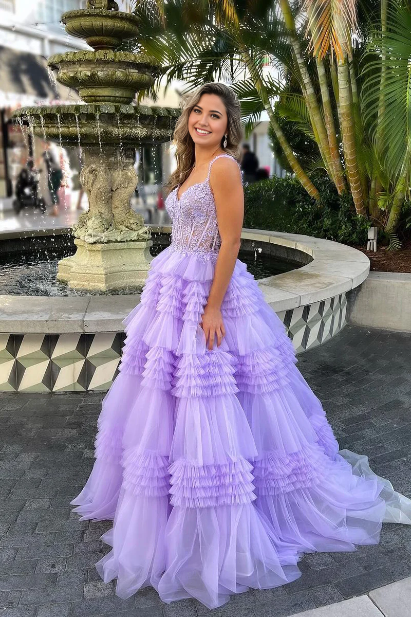Close-up of tiered tulle skirt and applique details on a lavender prom dress.