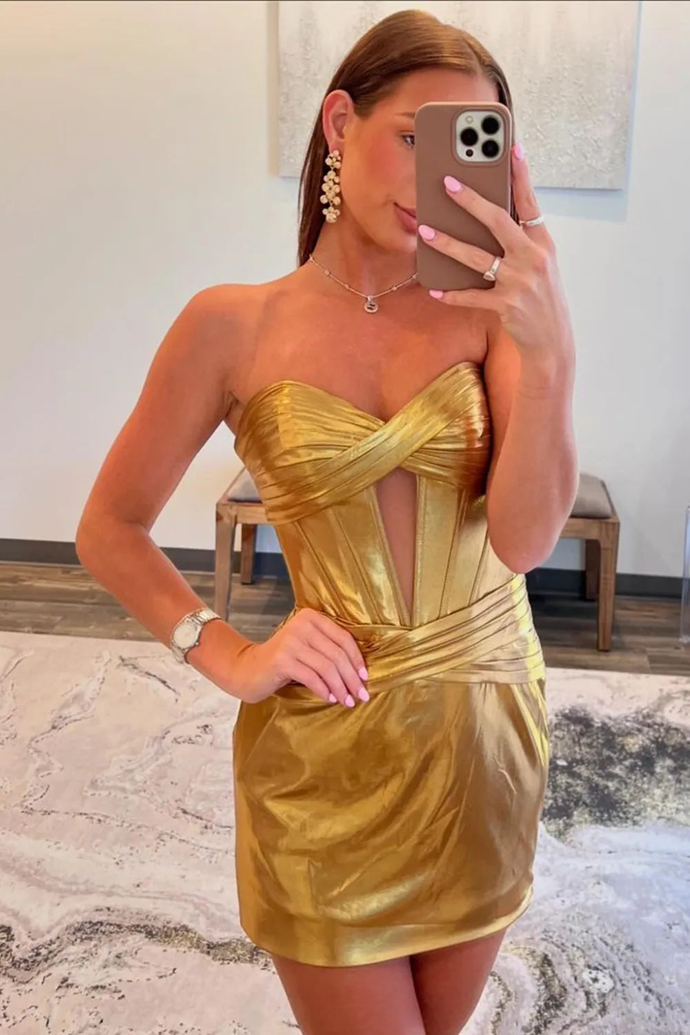 Model wearing a golden sweetheart bodycon corset homecoming dress with keyhole detail.