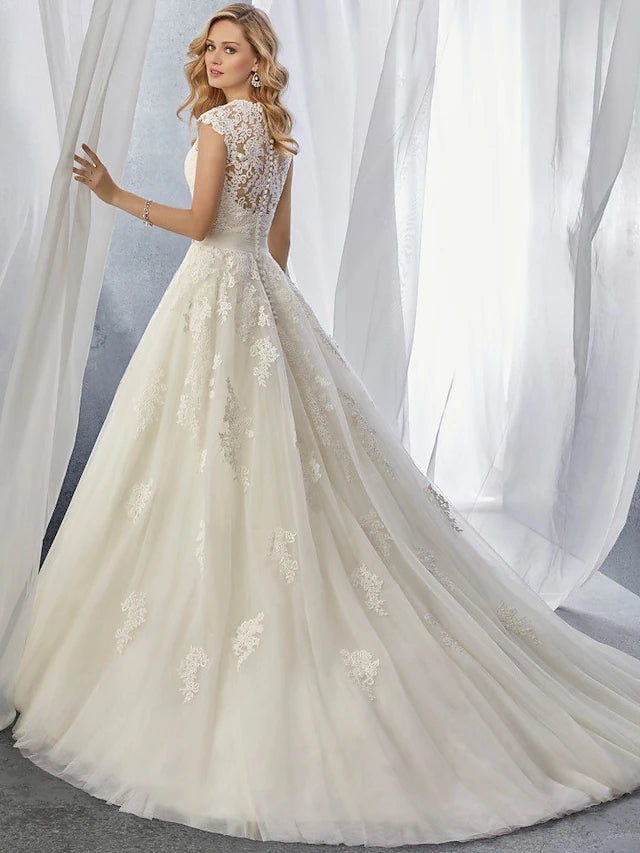 Close-up of lace appliques on the bodice of a wedding dress.