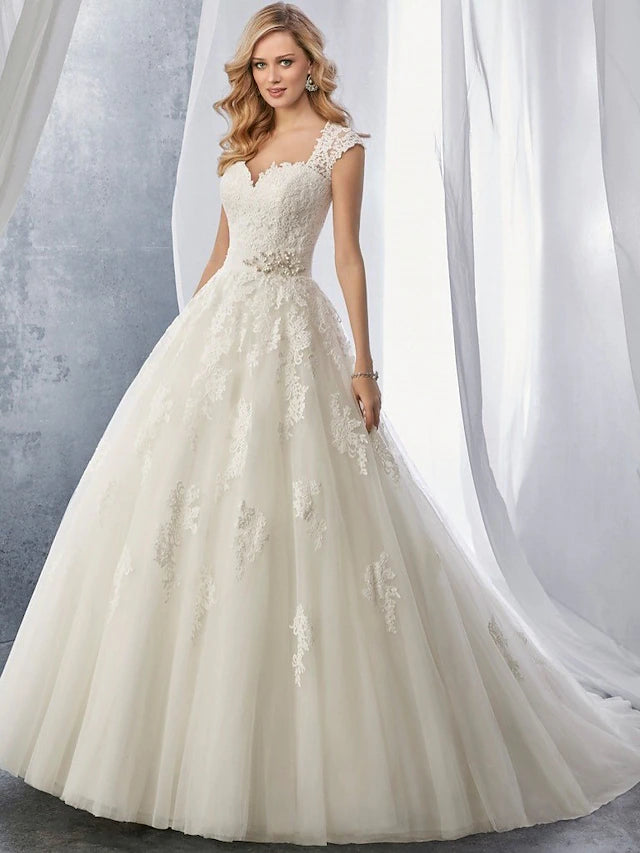 Back view of a bride in a white ball gown with a court train.