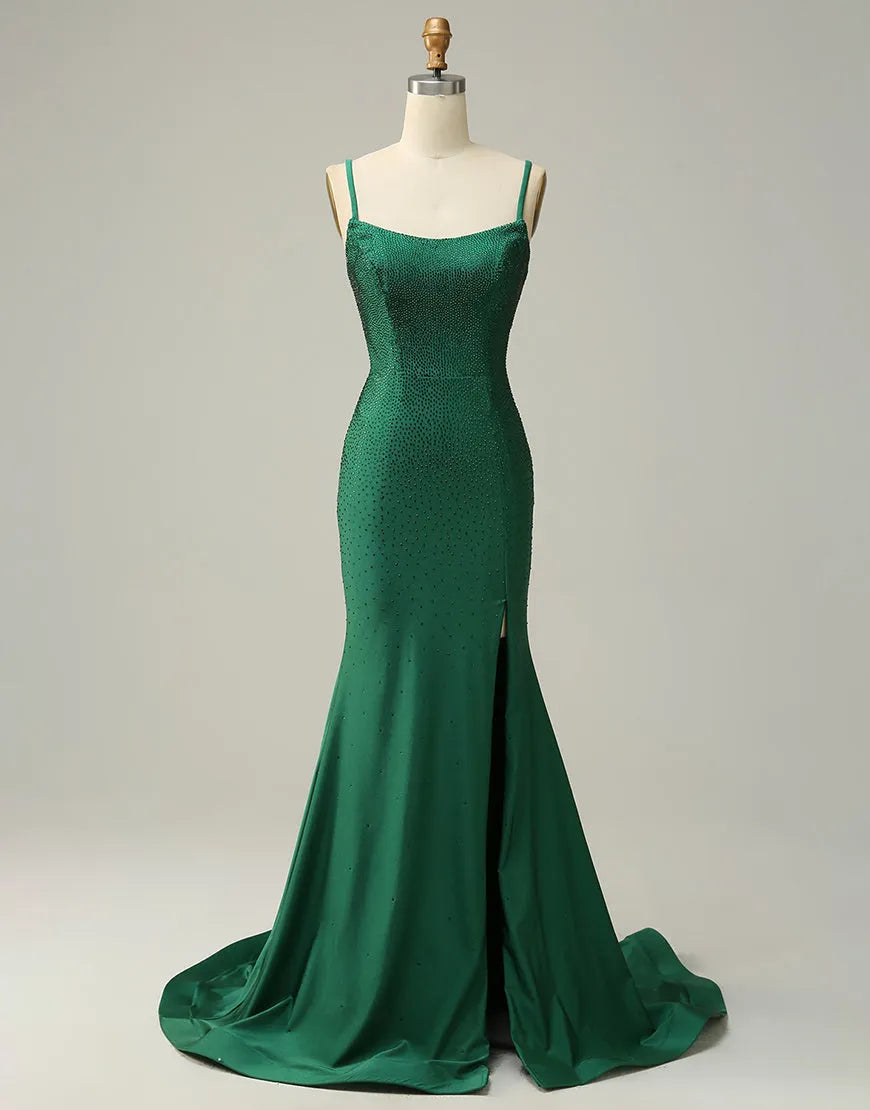 Dark green prom dress with spaghetti straps, corset back, and high slit.