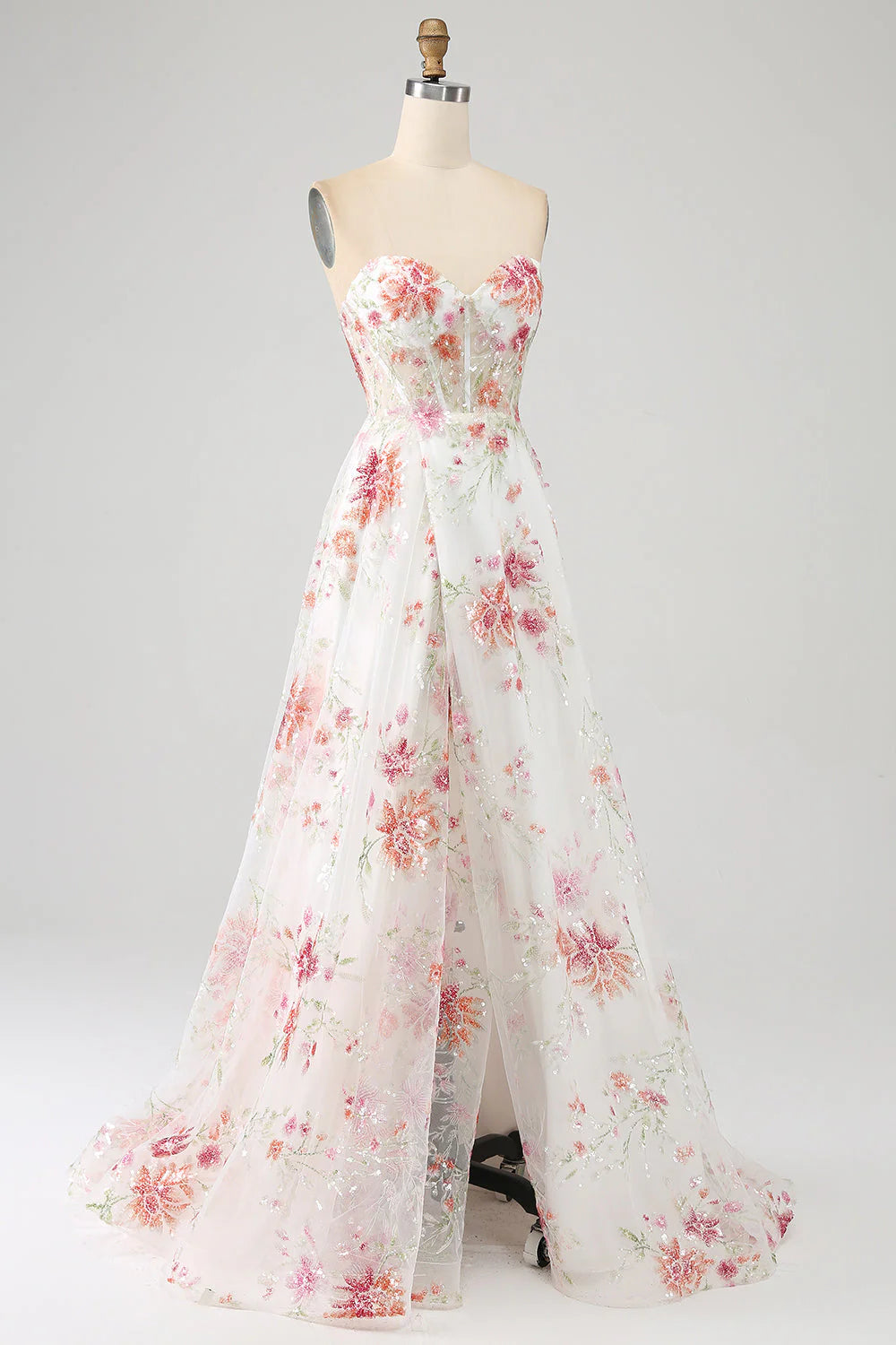 Close-up of the delicate floral embroidery on the ivory long prom dress.
