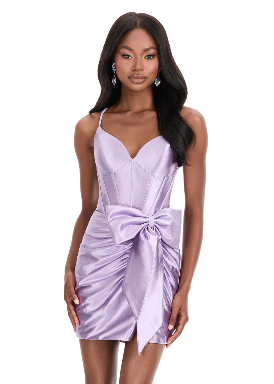 Model wearing a light blue sweetheart corset satin ruched mini homecoming dress with a side bow.