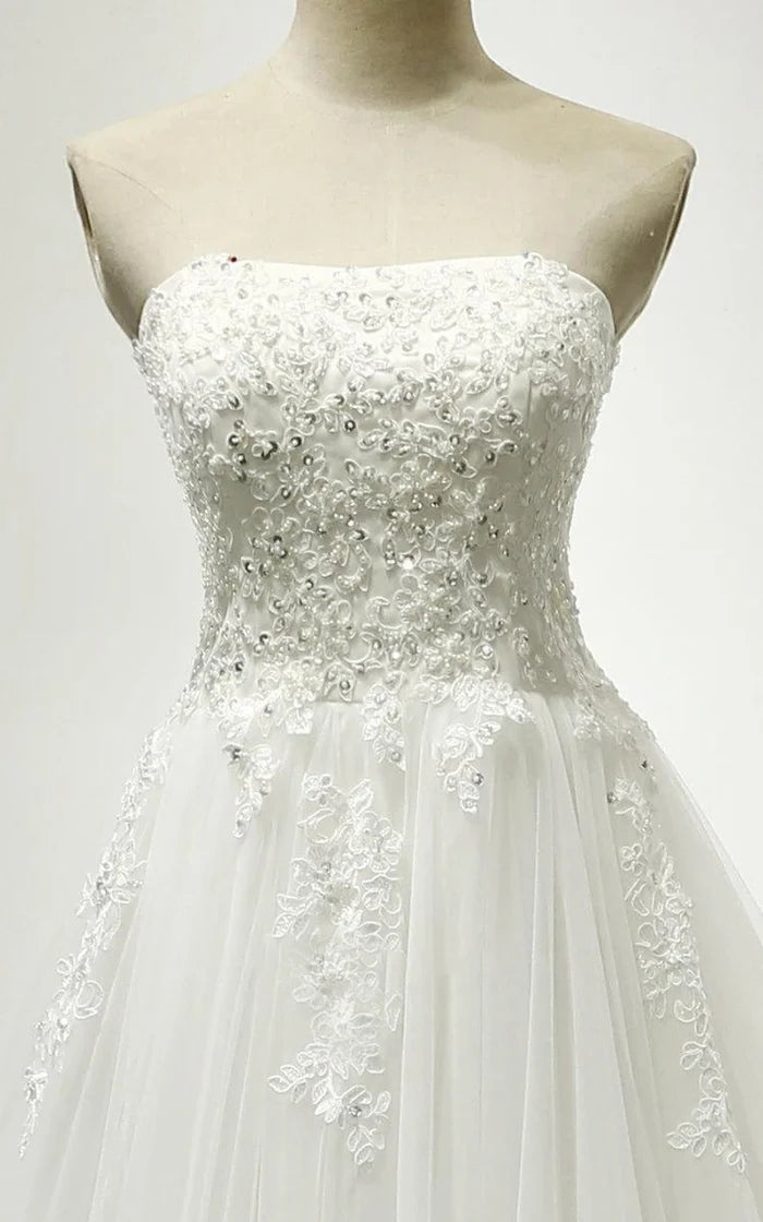 Front view of a romantic white tulle and lace wedding dress with sweetheart neckline.