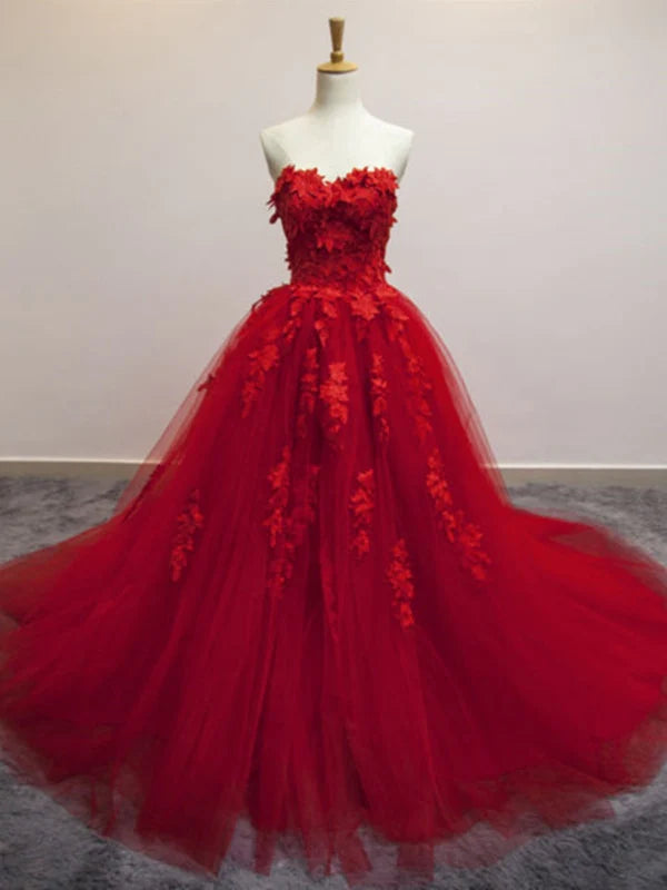 A woman wearing an elegant sweetheart neck lace appliques long prom gown.