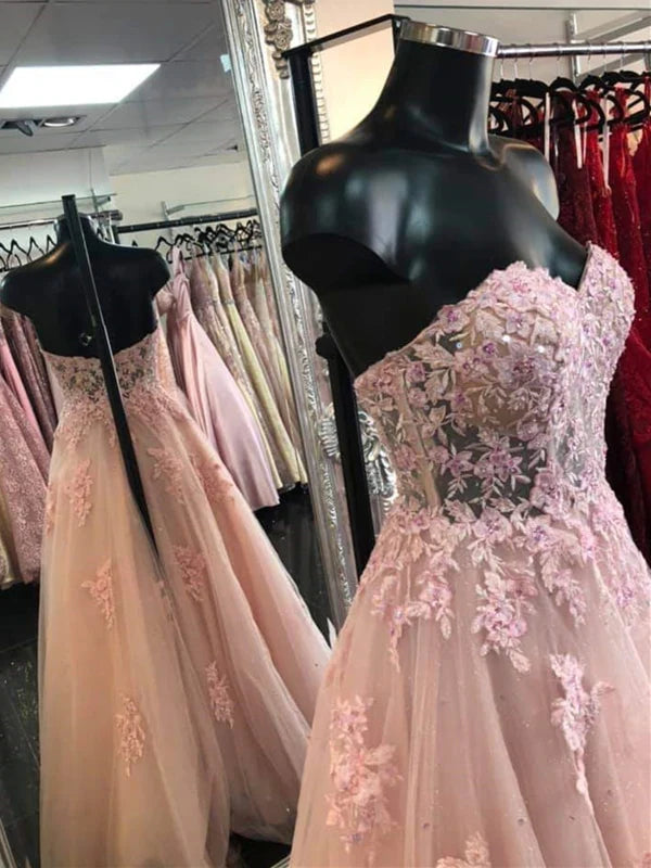 Back view of a long lace formal gown showing the open back design.