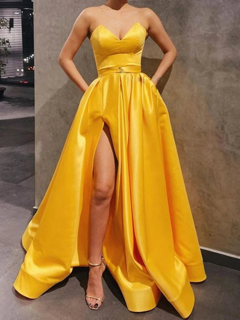Woman wearing a rose pink sweetheart neck satin long prom dress with a high slit.