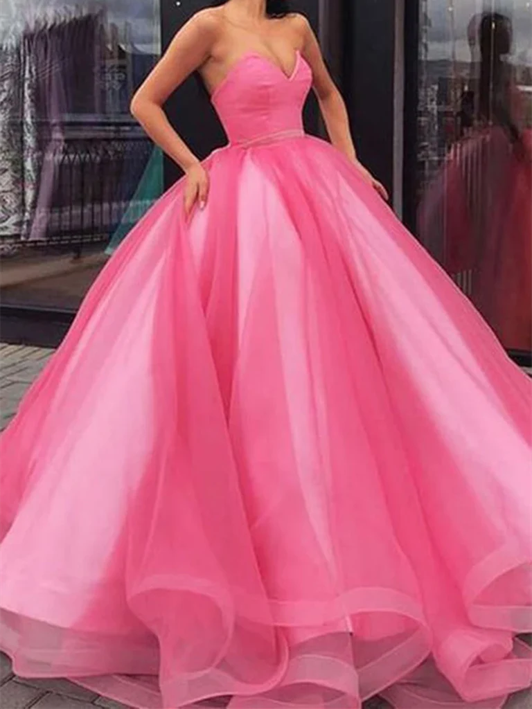 Woman wearing a long A-line sweetheart neck tulle prom dress.