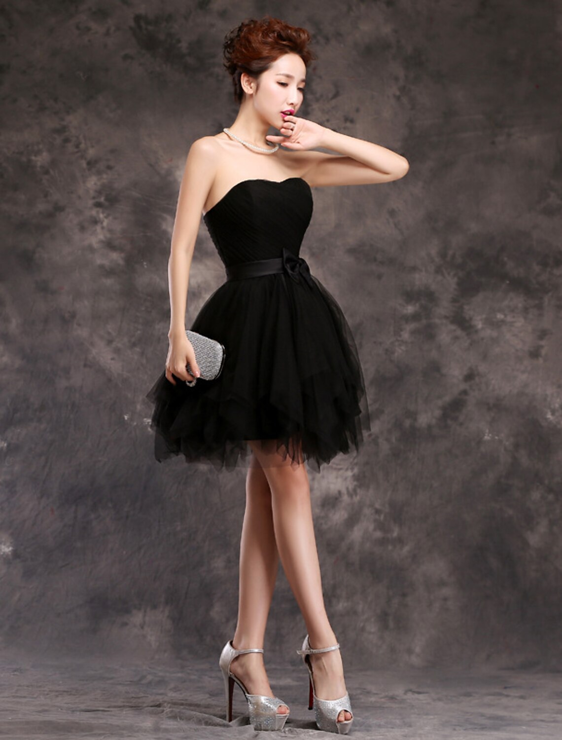 Back view of sweetheart tulle cocktail dress with bows.