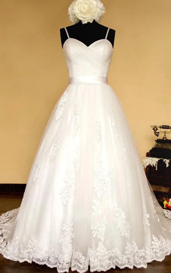 Back view of an elegant white wedding dress with a lace-up closure.