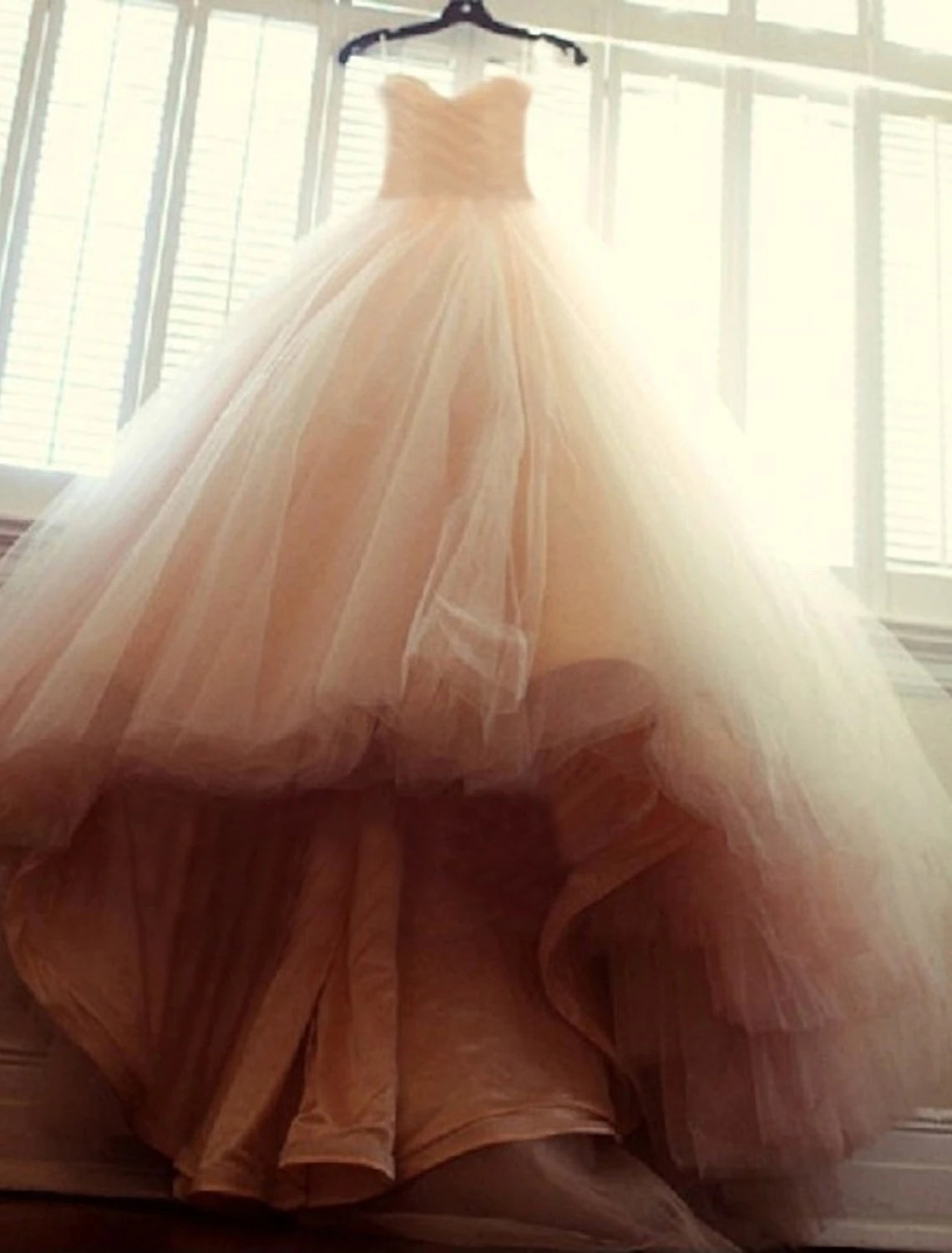 Full view of the elegant sweetheart strapless ball gown wedding dress from the back.