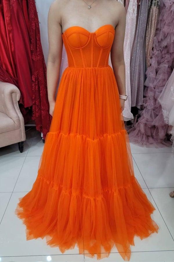 Side view of a sweetheart strapless tulle corset prom dress.