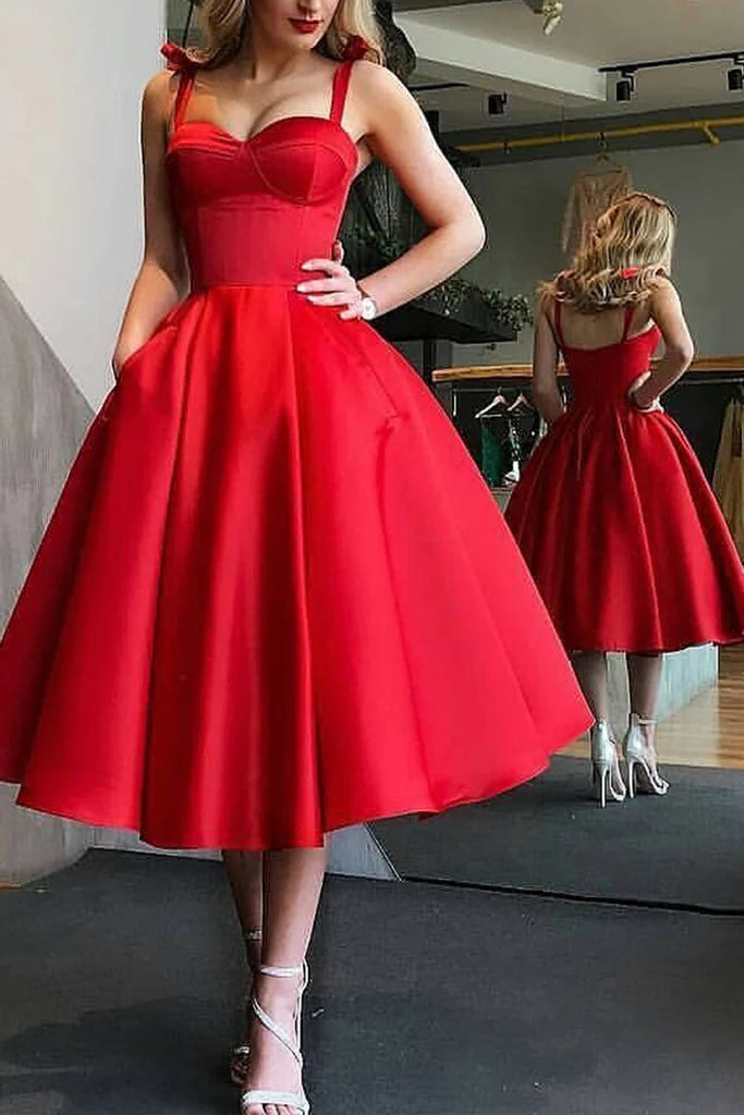 Elegant woman wearing a sweetheart neckline maxi prom dress with spaghetti straps in a studio setting.
