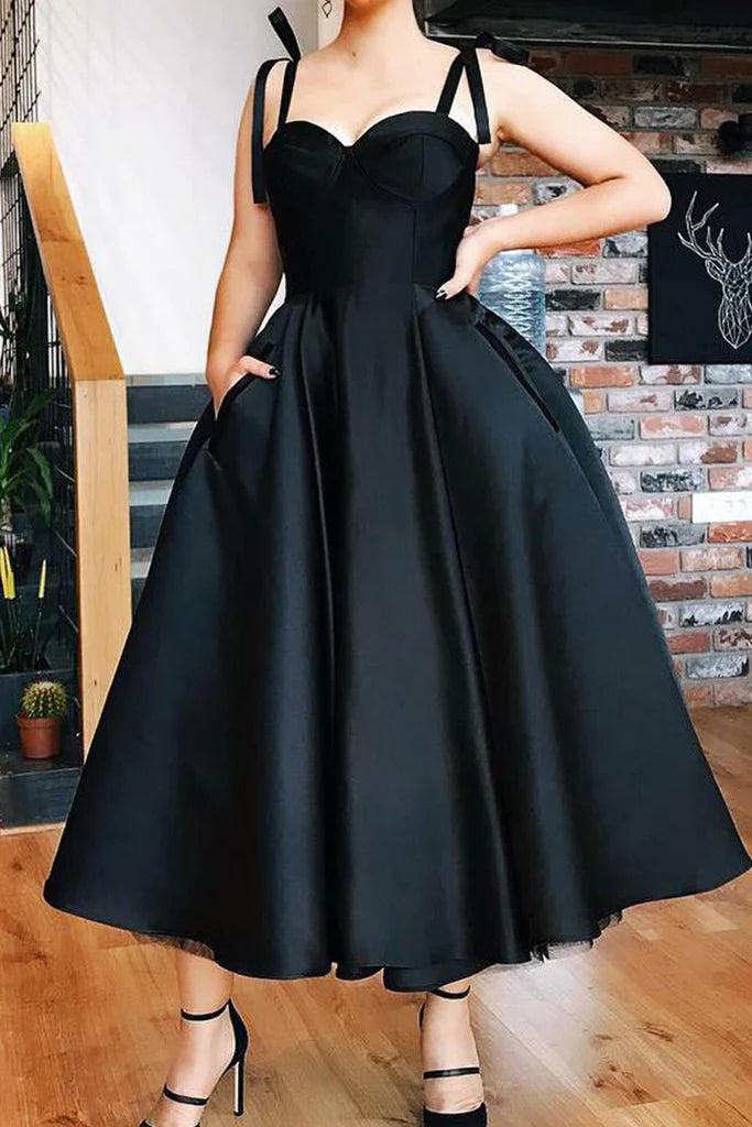 Back view of an elegant woman in a sweetheart neckline maxi prom dress with spaghetti straps, showcasing the flowing skirt.
